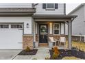 Inviting front porch with chairs, a wreath on the door, and manicured landscaping at 17227 Barnes St, Westfield, IN 46074
