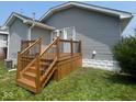 Back exterior view of the home with a wooden deck and stairs leading to the backyard at 18 S Franklin St, Greenfield, IN 46140