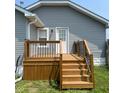Exterior shot showcasing a wooden deck with black railings and steps leading to the yard at 18 S Franklin St, Greenfield, IN 46140