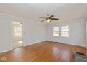 Bright living room featuring hardwood floors, a ceiling fan, and multiple windows at 1901 E 68Th St, Indianapolis, IN 46220
