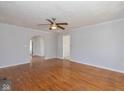Spacious living room with beautiful hardwood floors, ceiling fan, and arched doorways at 1901 E 68Th St, Indianapolis, IN 46220