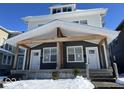 Two-story duplex with gray siding, white trim, and a covered porch at 2033 Carrollton Ave, Indianapolis, IN 46202