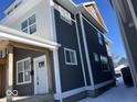 Side view of a duplex showcasing gray siding and white trim at 2033 Carrollton Ave, Indianapolis, IN 46202