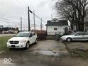 View of the home's backyard, with parking and a street in the background at 2165 S Meridian S St, Indianapolis, IN 46225