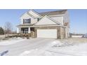 Two-story house with brick and siding, white garage door, and snow-covered lawn at 2248 Sante Fe Dr, Greenfield, IN 46140