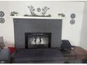 Dark gray brick fireplace with a black hearth and a built in window seat at 409 E Ulen Dr, Lebanon, IN 46052
