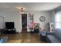 Living room with hardwood floors, gray couch, and French doors leading to another room at 409 E Ulen Dr, Lebanon, IN 46052