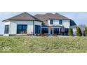 Rear view of a white brick house with a large backyard and patio area at 5465 S State Road 75, Jamestown, IN 46147