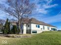 White brick house with stone accents, a large backyard, and mature trees at 5465 S State Road 75, Jamestown, IN 46147
