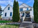 Stunning two-story white brick home with a welcoming front porch and lush landscaping at 5465 S State Road 75, Jamestown, IN 46147