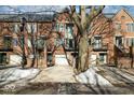 Brick townhome with attached garage and snowy walkway at 588 E Vermont St, Indianapolis, IN 46202