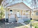 Modest home showcasing a porch and faded gray siding at 817 N Linwood Ave, Indianapolis, IN 46201