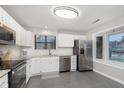 Updated kitchen featuring white cabinets, stainless steel appliances, and tile flooring at 8198 Wade Hill Ct, Indianapolis, IN 46256