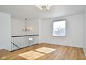 Light-filled living room with hardwood floors and modern chandelier at 9028 Caminito Ct, Indianapolis, IN 46234