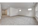 Bright and airy living room with grey carpet and access to hallway at 1011 Grassy Branch Dr, Indianapolis, IN 46239