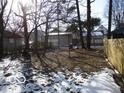 Spacious backyard with mature trees and a wooden fence at 1053 W 35Th St, Indianapolis, IN 46208