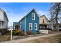 Inviting exterior of a two-story home with blue siding, red door, and neat landscaping at 1130 S Senate Ave, Indianapolis, IN 46225