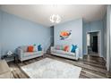 Bright living room featuring gray couches, stylish rug, and an open staircase at 1130 S Senate Ave, Indianapolis, IN 46225