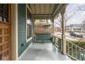 Inviting front porch with wooden swing, decorative railing, and a cozy, welcoming atmosphere at 1468 Alabama St, Indianapolis, IN 46202