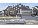 Two-story home with gray siding, brick accents, and attached garage at 15020 Stonneger St, Westfield, IN 46074