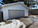 Detached single car garage with light gray door, some snow on ground at 1620 Union St, Columbus, IN 47201