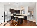 Modern kitchen with dark cabinets, granite counters, and stainless steel appliances at 17238 Falkland Dr, Westfield, IN 46074