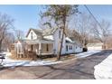 Two-story home with a detached garage and driveway, offering curb appeal at 2088 E Eden Rd, Greenfield, IN 46140