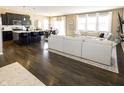 Open floor plan with hardwood floors, large sectional sofa, and kitchen island at 2394 Eagle Ave, Plainfield, IN 46168