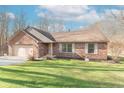 Charming brick home with an attached two-car garage and manicured lawn at 3510 E Copperstone Rd, Martinsville, IN 46151