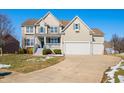 Two-story house with a three-car garage and landscaped yard at 4348 Princeton Park Dr, Columbus, IN 47201