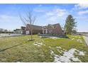 Brick home with attached garage and well-maintained lawn at 4543 W Meadows Ln, New Palestine, IN 46163