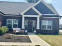 Inviting front entrance with a decorative wreath and charming bench seating at 4543 W Meadows Ln, New Palestine, IN 46163