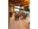Outdoor patio featuring comfortable seating, string lights, and ceiling fan for relaxed gatherings at 4543 W Meadows Ln, New Palestine, IN 46163