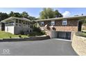 Brick home with attached garage and sunroom addition at 460 Park Pl, Martinsville, IN 46151