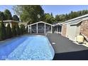 Refreshing blue pool with a gray deck and enclosure at 460 Park Pl, Martinsville, IN 46151