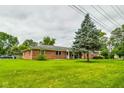 Brick ranch house with a large front yard at 4657 E 62Nd St, Indianapolis, IN 46220