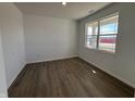 Bright, empty bedroom with wood flooring and a large window at 5209 Cartland Dr, Indianapolis, IN 46239