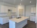 New kitchen features white cabinets, quartz countertops, and a large island at 5209 Cartland Dr, Indianapolis, IN 46239