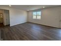 Spacious living room with wood flooring and natural light from a large window at 5209 Cartland Dr, Indianapolis, IN 46239