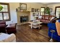 Inviting living room features a cozy fireplace, rich wood floors, and comfortable seating at 6551 Forrest Commons Blvd, Indianapolis, IN 46277