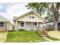 Charming craftsman home featuring a covered front porch, fresh paint, and landscaped front yard at 1206 Comer Ave, Indianapolis, IN 46203