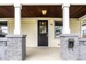 Inviting front porch with brick accents, a stylish front door, and ample space for relaxing at 1206 Comer Ave, Indianapolis, IN 46203