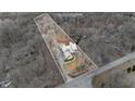 Aerial view of the property showcases the house's layout and surrounding land with mature trees at 14519 Cherry Tree Rd, Carmel, IN 46033