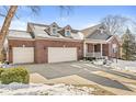 Two-story brick home with a two-car garage and a partially snow-covered front yard at 15131 Newburyport Dr, Fishers, IN 46040