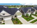 Luxury townhouses with attached garages, community lake, and lush landscaping at 17083 Cole Evans Dr, Noblesville, IN 46060
