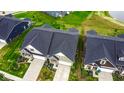 Modern townhouses with dark roofs, attached garages, and beautifully landscaped yards at 17083 Cole Evans Dr, Noblesville, IN 46060