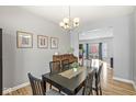 Formal dining room with a black table and hardwood floors at 2129 Keystone Pl, Columbus, IN 47203