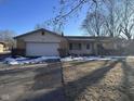 Ranch home with attached garage and snow covered lawn at 2147 W 65Th St, Indianapolis, IN 46260