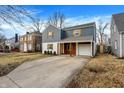Charming two-story home featuring blue siding, white brick, and a convenient attached covered carport at 3522 Janet Dr, Indianapolis, IN 46218