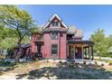 Side view of the charming red Victorian house, showcasing its architectural details at 404 N State St, Greenfield, IN 46140